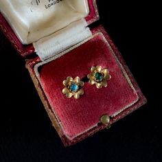 "Date: Mid Century  Origin: Italian Materials: 18K gold, Zircon Dimensions: 14mm x 8mm, 3 mm diameter cabochon These high quality hand formed earrings are in the shape of a sweet little flower. While tiny they are quite significant in weight for their size and fabricated of a solid 18k yellow gold as reflected with acid testing and a European purity mark of 750 located on the earring backs. The butterfly earring closures are further imprinted with an Italian maker's mark of '* 848 VI' and would indicate that whomever made the earrings was the 848th registered jeweller in the Italian province of Vicenza.  The gold itself is buttery with a delicate satin finish emphasizing the soft curving shape of each petal. Nestled within the centre of each flower is a small blue/green cabochon of zircon Formal Yellow Gold Flower Earrings, 14k Gold Earrings With Flower Charm For Gift, Vintage Gold Earrings With Flower Charm, 14k Gold Cabochon Earrings Gift, Yellow Gold Flower Earrings For Gift, Yellow Gold Flower Earrings As Gift, 14k Gold Flower Earrings For Gift, Vintage Yellow Gold Flower Earrings, Vintage Yellow Gold Flower Earrings For Gift