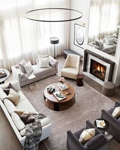 an aerial view of a living room with couches, tables and a fire place