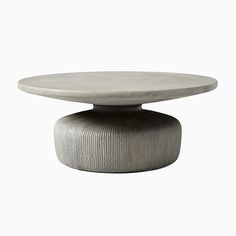 a round table with a white top and grey base, on a white background in the shape of an object