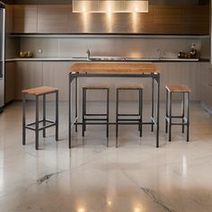 a modern kitchen with stainless steel appliances and wooden counter tops, along with marble flooring