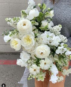 a bouquet of white flowers sitting on the ground