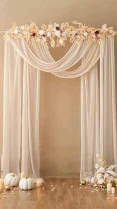 a wedding arch decorated with flowers and candles