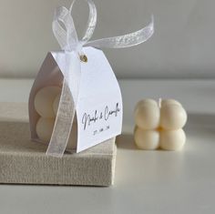 small white marshmallows sitting on top of a table next to a tag