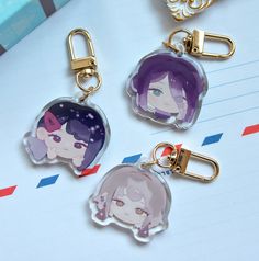 three key chains with anime characters on them