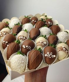 chocolate covered strawberries in a box with white and brown frosting on the top