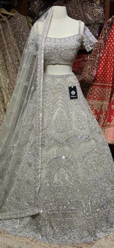 Iced cube sliver lehenga with frosted crystal embroidery teamed with a spaghetti strap blouse with crystal embroidery and net dupatta. Fabric: Net Size: 38 Ready to Ship! Silver Hand Embellished Sharara For Wedding, Silver Party Wear Sets With Intricate Embroidery, Designer Silver Organza Lehenga, Silver Lehenga With Intricate Embroidery For Party, Silver Party Wear Lehenga With Intricate Embroidery, Silver Anarkali Style Hand Embellished Sharara, Silver Hand Embellished Lehenga For Wedding, Silver Embellished Organza Lehenga, Silver Hand Embellished Wedding Lehenga