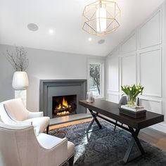 a living room filled with furniture and a fire place next to a table in front of a fireplace