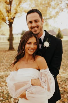 a man in a tuxedo hugging a woman