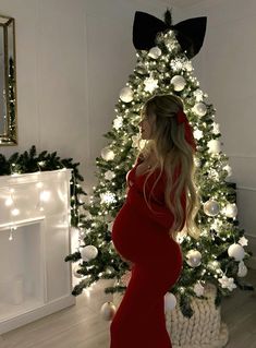 Pregnancy Photos By Christmas Tree, Christmas Couple Pregnancy Pictures, Pregnant Dinner Outfits Winter, Christmas Tree Maternity Silhouette, Red Gown Maternity Shoot, Indoor Maternity Photos Christmas, Christmas Photoshoot Ideas Pregnant, Christmas Tree Maternity Photos, Christmas Outfit Pregnant Women