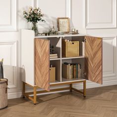 an open bookcase with two doors and some books on it in a white room