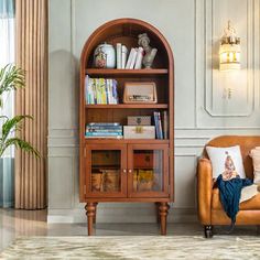 a living room filled with furniture and a book shelf