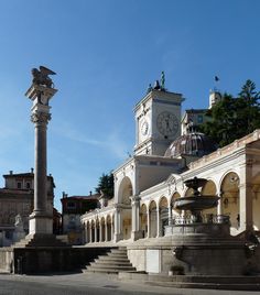 a clock tower in the middle of a courtyard