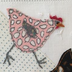 a close up of a piece of fabric with a bird on it