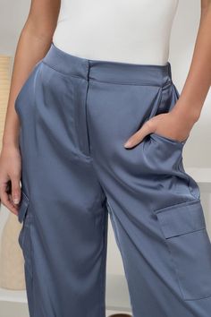 Elevate your style with our Denim Blue Satin Cargo Jogger Pants. The high waist and elasticized back provide a comfortable fit, while the hook and bar closure and zipper ensure a secure closure. Featuring multiple pockets and a drawstring cuff with stopper, these jogger pants offer a sleek satin texture and lightweight feel for versatile wear. Fabric & fit: 100% polyester Model is wearing size small. Satin Texture, Cargo Joggers, Pants Large, The Hook, Swimwear Sale, Blue Satin, Denim Blue, Jogger Pants, Blue Denim