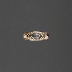 a gold ring with a stone in the middle