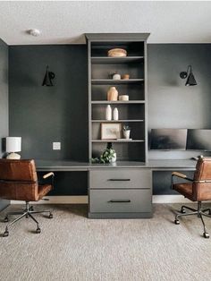 an office with two chairs and a desk in the corner, along with shelving units