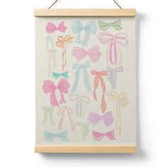 a painting hanging on a wall with different colored bow ties and bows in pastel colors