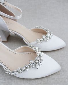 Classic satin almond toe block heels embellished with our glistening vine marquise rhinestone crystals across the front. The shimmering embellishment contrasted against the beautiful satin colors gives an ultra-chic look for any bride and bride squad.DETAILS:HEEL HEIGHT: 2.75 inchesUPPER: Synthetic upper and liningMATERIALS: Manmade outsoleSTYLE NAME: SALLY Block Heel Wedding Shoes, Satin Colors, Shoes Editorial, White Block Heels, Flower Girl Shoes, Ivory Wedding Shoes, Bridal Flats, White Wedding Shoes, Satin Shoes