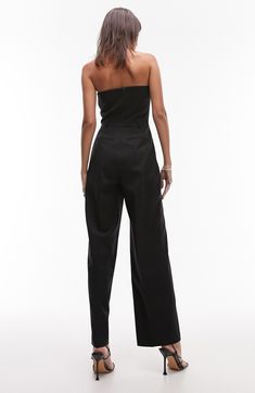 Bring sleek sophistication to your next event in this strapless jumpsuit designed with handy pockets and wide legs. Hidden back-zip closure Strapless Side pockets; back welt pockets 100% polyester Machine wash, line dry Imported Strapless Pantsuit For Night Out, Elegant Wide Leg Jumpsuits And Rompers With Pockets, Strapless Solid Color Jumpsuits And Rompers For Evening, Fitted Strapless Jumpsuits And Rompers With Pockets, High Waist Pantsuit With Pockets For Party, Party Overall Jumpsuits And Rompers With Pockets, Party Pantsuit With Pockets And Wide Leg, Party Wide-leg Pantsuit With Pockets, Party Wide Leg Pantsuit With Pockets