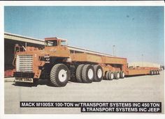 a large semi truck parked in front of a building