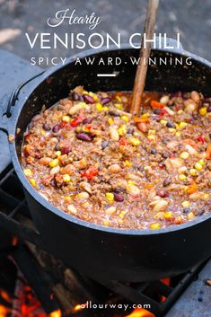 a skillet filled with chili and corn cooking over an open fire