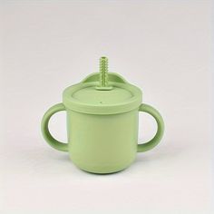 a green cup with a screw in it on a white background, there is no image here to provide a caption for