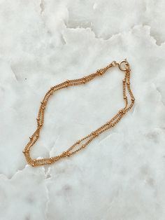 This is a beautiful double strand bracelet. It is made of 14/20 gold-fill and had small round gold beads attached to the chain all the way around. This bracelet has two chains attached to the same clasp, so it is an all in one layering bracelet. Length: 6.75 inches. If you need a different size please leave me a note at checkout. Matching Necklace: https://www.etsy.com/listing/239145000/double-strand-gold-beaded-chain-necklace?ref=shop_home_active_16 Gold Multi-strand Beaded Bracelets For Layering, Gold Double Strand Beaded Bracelet Gift, Gold Double Strand Beaded Bracelet For Gift, Gold Beaded Bracelets With Ball Chain For Everyday, Gold Adjustable Ball Chain Bracelet, Adjustable Double Chain Gold Bracelet, Gold Bracelets With Double Chain And Adjustable Fit, Gold Double Strand Bracelets With Delicate Chain, Everyday Gold Beaded Bracelets With Ball Chain