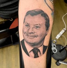 a man's arm with a portrait of him on it