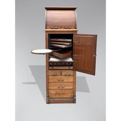 an old fashioned wooden cabinet with drawers and plates on it's shelf, in the shape of a mailbox