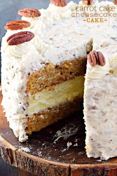 a carrot cake with white frosting and pecans on top is cut into slices