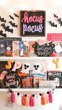 halloween decorations and books are displayed on the shelves in this kids's book room