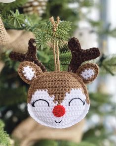 a crocheted reindeer ornament hanging from a christmas tree