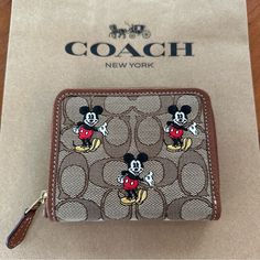 Coach X Disney/Cn035 Small Zip Around Wallet In Signature Jacquard With Mickey Mouse Print Original Price 228 Color: Khaki/Redwood Multi Material: Signature Jacquard And Refined Pebble Leather Size: 4.5" (L) X 3.75" (H) X 0.75" (W) Two Credit Card Slots Zip-Around Closure Bill Compartment Coach X Disney, Disney Wallet, Mickey Mouse Print, Coach New York, Mouse Print, Disney Disney, Purse Pouch, Color Khaki, Pebbled Leather