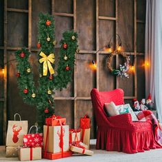 christmas presents sitting on the floor in front of a wooden paneled wall with lights