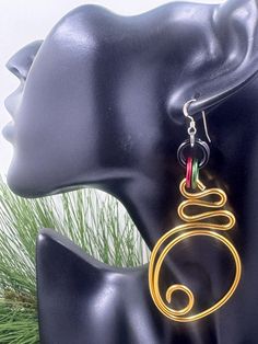 Check out these Wakanda Inspired Gold Abstract Earrings with an Afrocentric spin to them.  Handmade from anodized aluminum wire with sterling silver ear wires each pair is one of a kind light weight, non tarnishing and hypo allergenic.  This pair is about 3 inches long with gold, red and green accents.  Pair your earrings with on of the custom cuffs! https://www.etsy.com/listing/594855795/enjoy-15-off-cuff-bracelet-wakanda?ref=shop_home_active_20 Abstract Wire Earrings, Afrocentric Jewelry, Abstract Earrings, African Earrings, Green Accents, Anodized Aluminum, Jewelry For Her, Red Accents, Wire Earrings