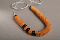 "Long orange necklace - this is a chunky paper-bead statement necklace. This avant-garde jewelry piece is an impressive mother-of-the-bride jewelry and can be an exciting jewelry gift for grandma. This lightweight paper bead necklace is handmade of hundreds of circular paper disc beads in bold mustard-orange color, combines with black paper beads, and finished with wood beads. It is a bold & beautiful necklace, and the fact that it is hand-made of recycled paper beads gives it that extra meaningful glamour. All my jewelry is 100% handmade. For me, the process of taking an extremely common material such as paper, and transforming it into valuable, unique jewelry, is incredibly fascinating and challenging. This statement blue necklace will add that special touch of contemporary chic to your Unique Orange Necklace With Wooden Beads, Mother Of The Bride Jewelry, Orange Statement Necklace, Paper Bead Necklace, Avant Garde Jewelry, Paper Beads Necklace, Orange Necklace, Chunky Statement Necklace, Necklace Chunky