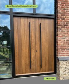 an image of a wooden front door with sidelights and glass panels on brick building