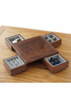 three wooden boxes with jewelry inside on a table