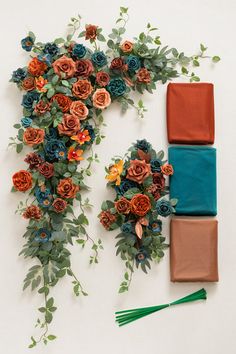 an arrangement of flowers and foliage on a white background with three different color fabrics laid out next to each other