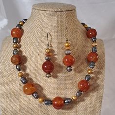 This 16" Choker Style Necklace Has A Huge Amount Of Genuine Carnelian! Look At The Size Color Of These 1/2" Round Beads That Pop With Various Colors Of Orange To Red. Carnelian Stone Chips Accent The Necklace Along With Dyed Gold And Pewter Colored Fresh Water Pearls And Seed Beads. Beautiful Hand Crafted Closure Is Made With Gold Filled Wire. Matching Pierced Earrings Measure 1 1/2" And Hang From French Ear Wires. Gorgeous Statement Necklace To Wear With A Collared Button Up Blouse Or With A To Terracota Jewellery Making Necklace Set, Elegant Orange Agate Necklace, Orange Gemstone Beads Round Jewelry, Orange Round Gemstone Bead Jewelry, Orange Round Gemstone Beads Jewelry, Artisan Orange Jewelry With Round Beads, Artisan Orange Round Bead Jewelry, Handmade Orange Agate Jewelry, Artisan Orange Gemstone Necklace