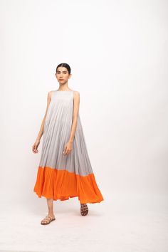 Grey-Orange halter neck maxi dress with gathers throughout and orange gathers at the end of it.Party Wear, Casual, Office Wear, Day Wear, Holiday Wear Fabric : Bemberg Modal Silk Grey-Orange Color Butter Crepe Lining Colorblocked Pattern 7-14 days Delivery Dry clean only Dress With Gathers, Orange Color Block, Bridal Lehenga Red, Halter Neck Maxi Dress, Color Naranja, Halterneck Dress, Bamboo Fabric, Colorblock Dress, Fashion Plates