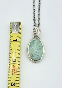 Nice amazonite cabochon-- see all pics especially close ups. Stone has a few areas of rough finish that flash with chatoyancy! Video found on my instagram @leetwraps This is made from .925 sterling silver. Ready to wear! Comes on an 18 inch stainless steel chain as seen in the photos... also comes in a gift box and with a polishing cloth. Handmade Silver Larimar Jewelry, Handmade Silver Jewelry With Larimar, Silver Larimar Jewelry For Healing, Silver Amazonite Round Jewelry, Oval Amazonite Jewelry As Gift, Oval Amazonite Jewelry Gift, Oval Amazonite Jewelry For Gift, Silver Amazonite Gemstone Jewelry, Untreated Jade Jewelry Gift