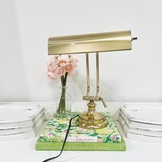 a table lamp sitting on top of a green book