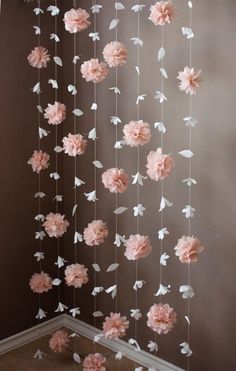 pink and white flowers hanging from the ceiling