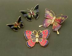 This set of butterfly brooches includes a set of two scatter pins painted with black, green and red, a cloisonne style enamel pin in red and deep blue and a glitter pin of light green, pink and deep purple. All are in gold-tone metal.  Nice vintage condition.  Please see photos.  Unmarked. Sizes range from1" to 1-3/4" wide *Please note that I have tried to describe and photograph the details and colors as accurately as possible.  However, the colors may appear slightly different on your computer screen. Butterfly-shaped Enamel Pin Gift, Butterfly Shaped Enamel Pin For Gifts, Multicolor Butterfly Brooches As Gift, Glitter Pin, Red A, Butterfly Brooch, Vintage Butterfly, Green And Red, Computer Screen