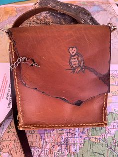 Cute Owl on tree  Brown leather purse. The clasp is a charming key. 8x7 with and 18 inch strap. Beautiful but tough! This hand stitched ( saddle stitch ) has lots of room for rocks if you are a Southwest girl like me . All genuine leather. Happy Trails. This little guy has a blemish on the back left corner so he is priced accordingly Brown Hand-tooled Satchel For Travel, Hand Tooled Brown Satchel For Travel, Brown Hand Tooled Satchel For Travel, Hand-stitched Brown Bag As A Gift, Brown Hand-stitched Bag As A Gift, Brown Hand-stitched Bag As Gift, Brown Hand-stitched Bag For Gift, Hand-tooled Brown Crossbody Satchel, Hand-stitched Brown Shoulder Bag For Gift