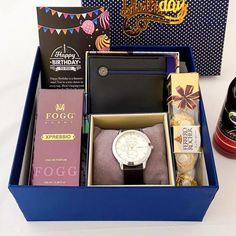 a birthday gift box with wine, books and other items