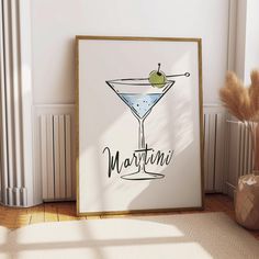 there is a martini poster on the wall next to a vase and potted plant