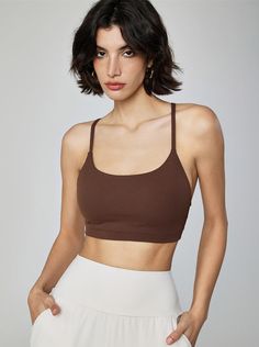 Why We Love It: Achieve peak performance and effortless style with the Gemma Cami Sports Bra. This versatile piece combines a chic design with essential support, perfect for any workout routine. Fit and Features: Light-to-medium support for a wide range of activities. Built-in bra with removable padding for customizable comfort. Scoop neckline adds a touch of elegance. Adjustable straps ensure a perfect fit. Breathable and moisture-wicking fabric keeps you cool and dry. Seamless construction pro Brown Fitted Sporty Activewear, Sporty Brown Activewear For Training, Brown Athleisure Activewear For Gym, Brown High Stretch Activewear For Sports, Brown High-stretch Activewear For Sports, High Stretch Brown Activewear For Sports, Brown Compressive Activewear For Gym, Brown Athleisure Activewear For Training, Brown Fitted Sports Bra For Gym