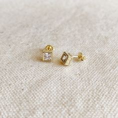 Attention to detail is our motto. These earrings are just an incredible piece of art with a detailed bezel featuring a square 5mm clear cubic zirconia and a unique design on the sides. Metal: 18k gold-filled 1/20 High-quality squared 5mm AAAAA cubic zirconia Waterproof Hypoallergenic Handcrafted by GoldFi in Brazil Classic Gold Earrings With White Topaz, Classic Gold White Topaz Earrings, Diamond-shaped Cubic Zirconia Earrings For Gift, Rectangular Cubic Zirconia Earrings As Gift, Diamond-shaped Cubic Zirconia Earrings As Gift, Gold White Topaz Earrings In Fine Jewelry Style, Cubic Zirconia Earrings With Bezel Setting For Gifts, Rectangular Cubic Zirconia Earrings For Gifts, Gold Square Earrings For Anniversary